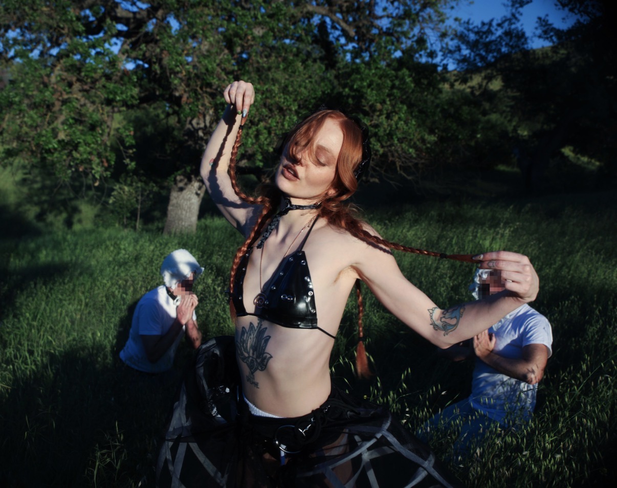 Mistress Luna in black shepherdess styling with submissive sheep figures